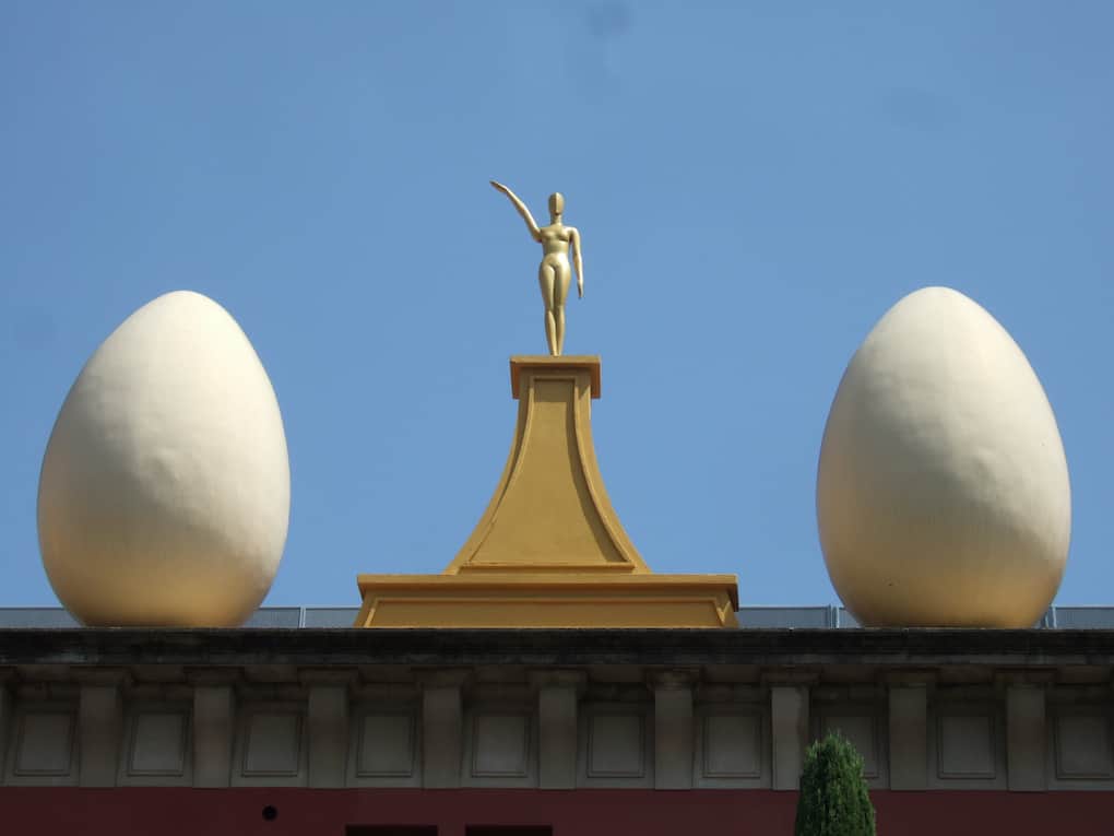 Dos huevos de Dalí con una escultura en el medio